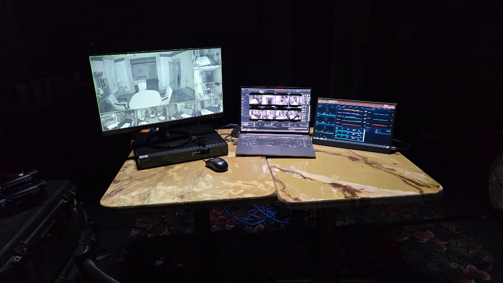 A real field setup: a security monitor and NVR next to a laptop running the main SPECTER app and a second screen running the Instrument Bay display.